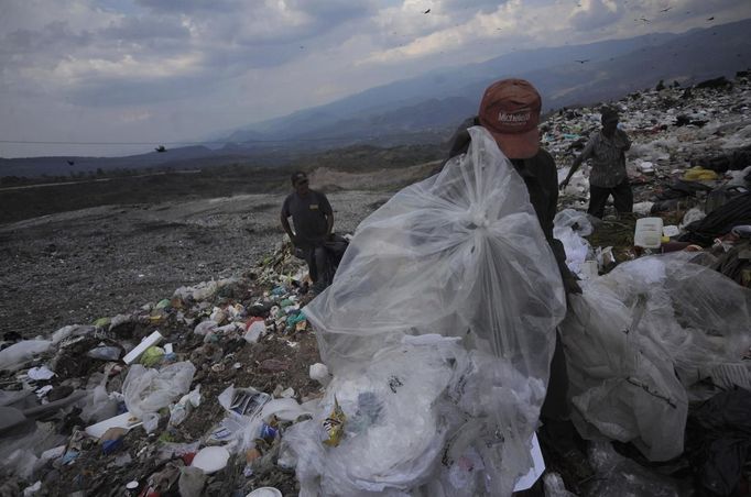 Garbage collectors look for recyclable waste at a municipal dump site in Tegucigalpa