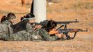 A female fighter of the Kurdish People's Protection Units (YPG) fires a Rocket-propelled grenade (RPG) as she participates in a military training