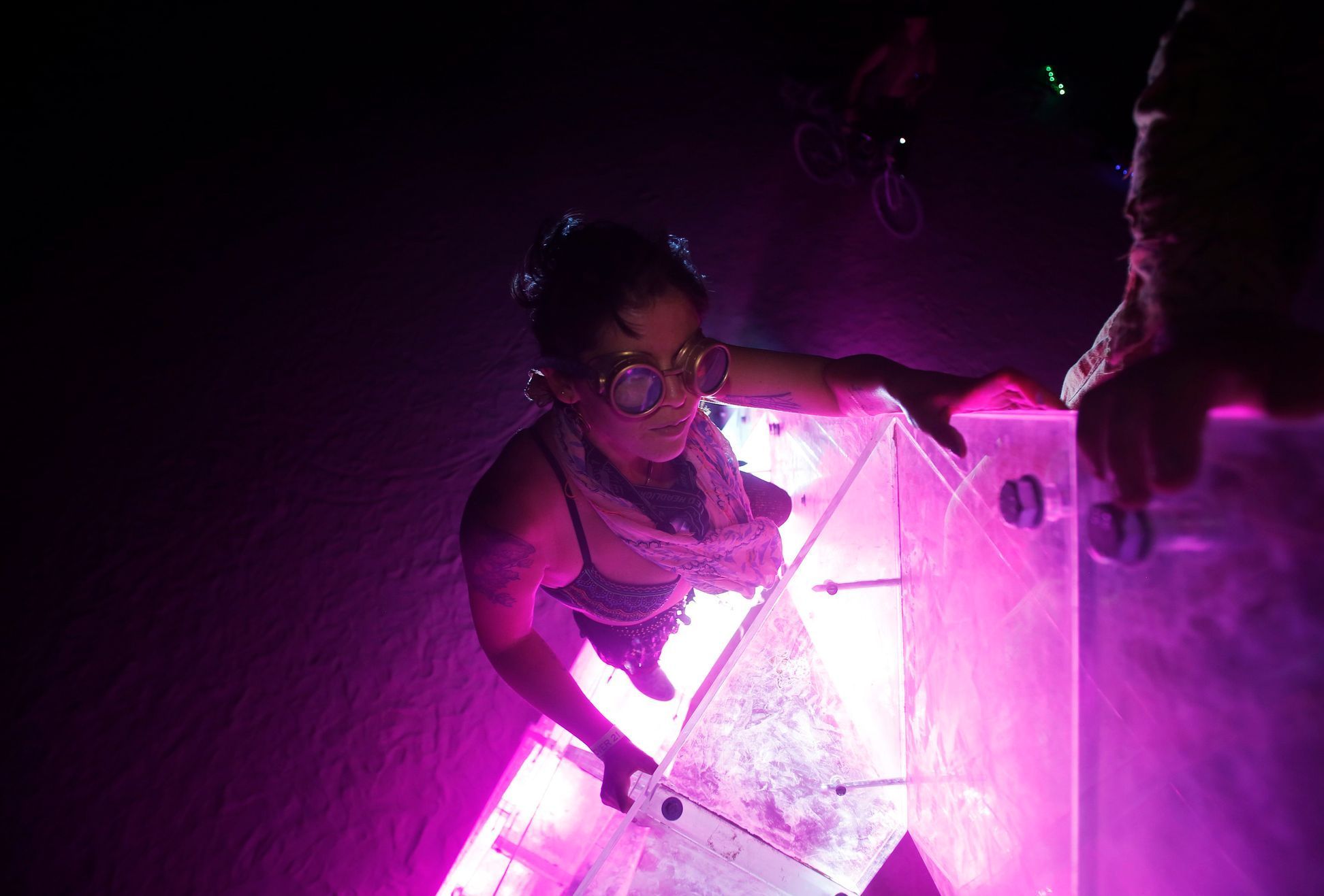Lynlea Michaels climbs the art installation LumenEssence during the Burning Man 2014 &quot;Caravansary&quot; arts and music festival in the Black Rock Desert of Nevada