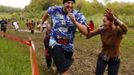 A zombie chases a runner (L) on the "Run for Your Lives" 5K obstacle course race in Amesbury, Massachusetts May 5, 2012. Runners face man-made and natural obstacles on the course, while being chased by zombies, who try to take "health" flags off the runners belts. REUTERS/Brian Snyder (UNITED STATES - Tags: SPORT SOCIETY) Published: Kvě. 5, 2012, 8:08 odp.