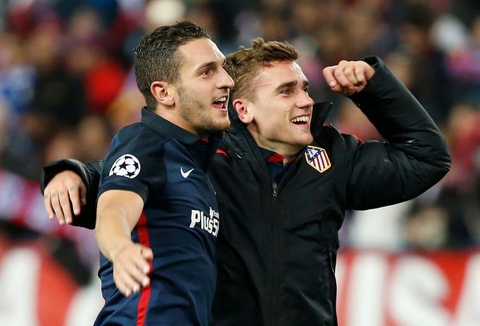 Atletico's Koke and Antoine Griezmann celebrate at the end of the game