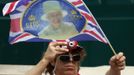 A man takes a picture of a Union flag as spectators line Parliament Square to see the Queen in London June 5, 2012. Four days of nationwide celebrations during which millions of people have turned out to mark the Queen's Diamond Jubilee conclude on Tuesday with a church service and carriage procession through central London. REUTERS/Kevin Coombs (BRITAIN - Tags: SOCIETY ROYALS) Published: Čer. 5, 2012, 1:35 odp.