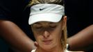 Maria Sharapova of Russia eats a banana as she rests between games against Petra Kvitova of the Czech Republic during their WTA Finals tennis match at the Singapore Indoo