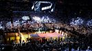 A large U.S. flag is unfurled on the court during ceremonies ahead of Game 7 of the NBA Finals basketball playoff between the San Antonio Spurs and the Miami Heat in Miam