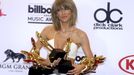 Singer Taylor Swift poses backstage with her awards at the 2015 Billboard Music Awards in Las Vegas