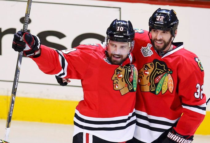 Chicago Blackhawks' Patrick Sharp (L) celebrates his goal against the Boston Bruins with teammate Michal Rozsival during the first period in Game 2 of their NHL Stanley C