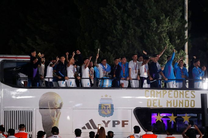 Soccer Football - Argentina team arrives to Buenos Aires after winning the World Cup  - Buenos Aires, Argentina - December 20, 2022 Argentina's players with the trophy du