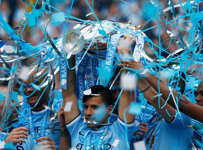 Manchester City's Sergio Aguero celebrates with the English Premier League trophy following their soccer match against West Ham United