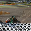 Track marshalls remove the car of Caterham Formula One driver van der Garde of Netherlands after he crashed, during the Japanese F1 Grand Prix at the Suzuka circuit