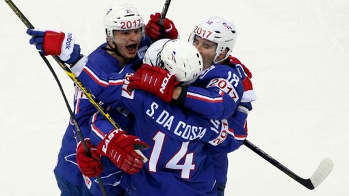 Stephane Da Costa of France (C) celebrates with team mates Antoine Roussel (L) and Yohann Auvitu (R) his second goal against Canada during the third period of their men's