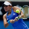 Monica Puig of Puerto Rico hits a return to Flavia Pennetta of Italy during their women's singles match at the Australian Open 2014 tennis tournament in Melbourne