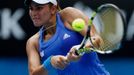 Monica Puig of Puerto Rico hits a return to Flavia Pennetta of Italy during their women's singles match at the Australian Open 2014 tennis tournament in Melbourne January