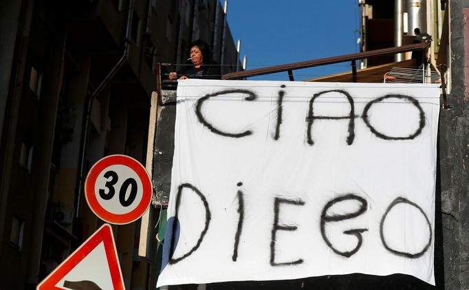 A woman hangs out on a balcony a sheet reading "Bye Diego" to mourn the death of Argentine soccer legend Diego Maradona, in Naples, Italy November 26, 2020. REUTERS/Yara