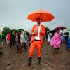 A man dressed in an orange suit watches Robert Plant on the Pyramid stage at Worthy Farm in Somerset, during the Glastonbury Festival