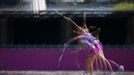 Czech Republic's Petra Kvitova serves during a training session at the All England Lawn Tennis Club before the start of the London 2012 Olympic Games in London July 26, 2012. Picture taken using multiple exposures. REUTERS/Stefan Wermuth (BRITAIN - Tags: SPORT OLYMPICS TENNIS TPX IMAGES OF THE DAY) Published: Čec. 26, 2012, 12:02 odp.