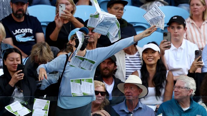 Tennis - Australian Open - Melbourne Park, Melbourne, Australia - January 22, 2024 A woman throws flyers that says "Free Palestine", amid the ongoing conflict between Isr