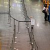 Two passengers stand at the check-in counters of German air carrier Lufthansa at Fraport airport in Frankfurt