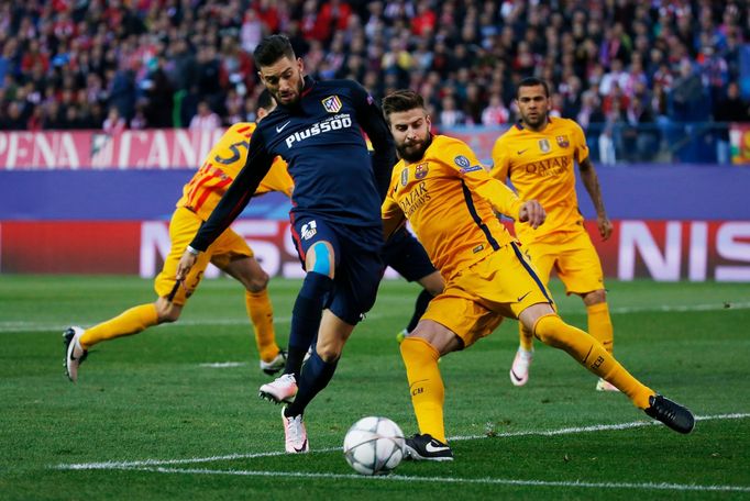 Atletico's Yannick Ferreira-Carrasco in action with Barcelona's Gerard Pique