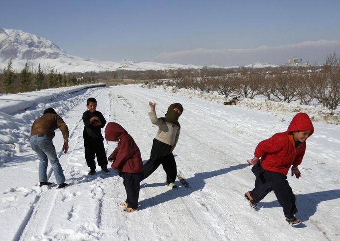 Afghánští chlapci si hrají ve sněhu v Kábulu.