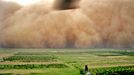 A picture released by the US Army 18 May 2006 shows a UH-60 Black Hawk helicopter door-gunner observeing a massive sand storm as it rolls its way towards US military Camp Taji, north of Baghdad, 08 May 2006.