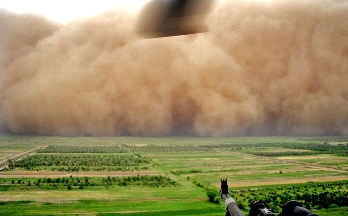 A picture released by the US Army 18 May 2006 shows a UH-60 Black Hawk helicopter door-gunner observeing a massive sand storm as it rolls its way towards US military Camp Taji, north of Baghdad, 08 May 2006.