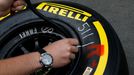 An engineer checks the air pressure of a new Kevlar-enforced Pirelli rear tyre of McLaren Formula One driver Jenson Button of Britain July 4, 2013, in preparation for thi