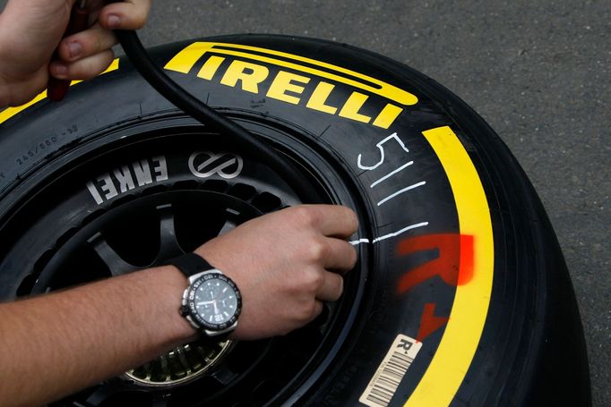 An engineer checks the air pressure of a new Kevlar-enforced Pirelli rear tyre of McLaren Formula One driver Jenson Button of Britain July 4, 2013, in preparation for thi