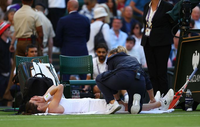 Tennis - Wimbledon - All England Lawn Tennis and Croquet Club, London, Britain - July 6, 2023 France's Alize Cornet receives medical attention after sustaining an injury