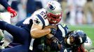 Feb 1, 2015; Glendale, AZ, USA; Seattle Seahawks running back Marshawn Lynch (24) is tackled by New England Patriots defensive end Rob Ninkovich (50) and outside lineback