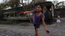 Ruth plays outside a train carriage she calls home in Cadereyta on the outskirts of Monterrey August 8, 2012. Ruth, her eight other family members and their pets have been living in the abandoned carriage next to a train track for the last 15 years. Ruth's grandparents moved from Tamaulipas to Cadereyta after one of their sons was killed on the street by a stray bullet. The family moved into the carriage which was empty after having been occupied by a vagabond, after living for the first five years in a rented room after arriving in Cadereyta. Picture taken August 8, 2012. REUTERS/Daniel Becerril (MEXICO - Tags: SOCIETY) Published: Srp. 11, 2012, 2:17 dop.