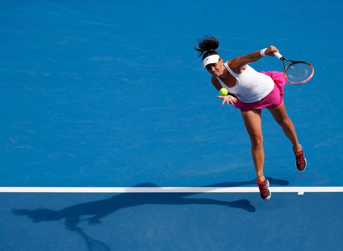 Casey Dellacqua of Australia serves to Kirsten Flipkens of Belgium during their women's singles match at the Australian Open 2014 tennis tournament in Melbourne January 1