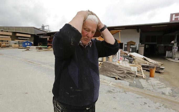 Wood mercantilist Walter Hundshammer, 73, reacts as he walks over his devastated firm founded by his grandfather in 1909 in Natternberg, a suburb of the eastern Bavarian city of Deggendorf June 10, 2013. Hundshammer said that he estimates the damage over one million Euros after the floods of the nearby Danube river subsided. REUTERS/Wolfgang Rattay (GERMANY - Tags: DISASTER ENVIRONMENT)