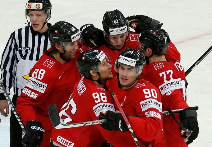 Switzerland's Damien Brunner (front, L) celebrates his goal against Germany with team mate Constantin Braun (front, R) during the first period of their men's ice hockey W