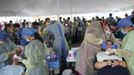 Dentists work on patients at the Remote Area Medical (RAM) clinic in Wise, Virginia July 20, 2012. RAM clinics bring free medical, dental and vision care to uninsured and under-insured people across the country and abroad. The Wise clinic was the 647th RAM expedition since 1985 and drew 1700 patients from 14 states, organizers said. Picture taken July 20, 2012. REUTERS/Mark Makela (UNITED STATES - Tags: HEALTH SOCIETY) Published: Čec. 24, 2012, 3:06 odp.