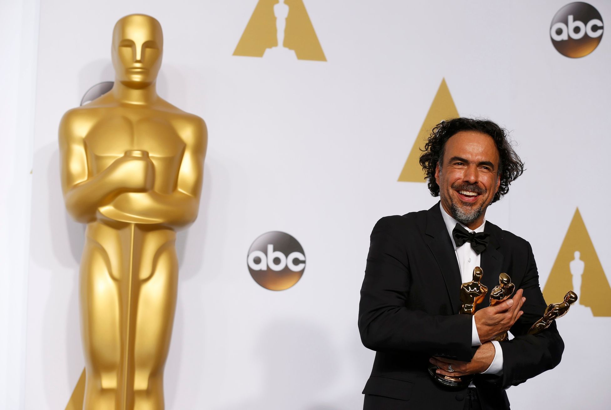 Director Alejandro Inarritu poses with the Oscars for Best Director, Best Original Screenplay and Best Picture at the 87th Academy Awards in Hollywood, California