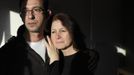 George Kapetanios poses for a photograph with his wife Katarina Germanou at their flat in Potters Bar, on the outskirts of London