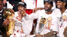 Miami Heat's Dwyane Wade (L), LeBron James (C) and Chris Bosh celebrate winning the NBA Championship following Game 7 of their NBA Finals basketball playoff against the S