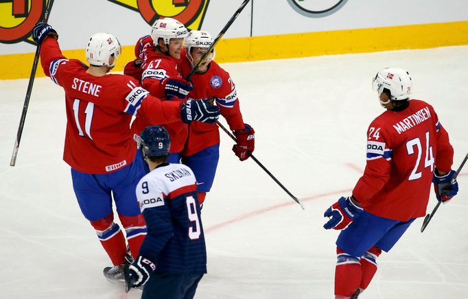 Norway's Alexander Bonkskasen (top C) celebrates his goal against Slovakia with team mates during the first period of their men's ice hockey World Championship group A ga