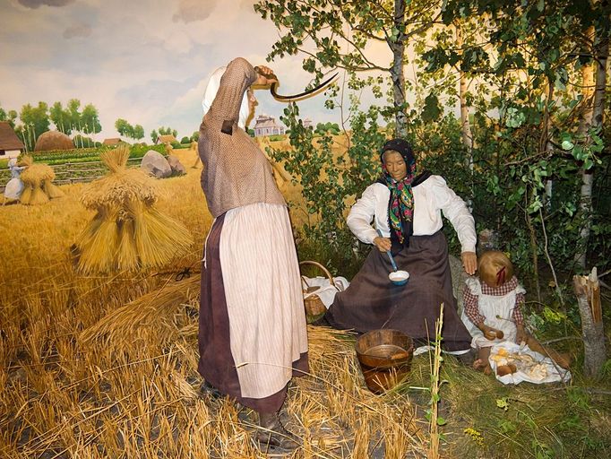 Diorama in Manitoba Museum of early pioneering farmers harvesting on the Canadian plains. Here, a Uk