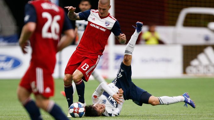 May 25, 2019; Vancouver, British Columbia, CAN; FC Dallas forward Zdeněk Ondrášek (13) knocks over Vancouver Whitecaps FC midfielder Hwang In-Beom (4) during the second h