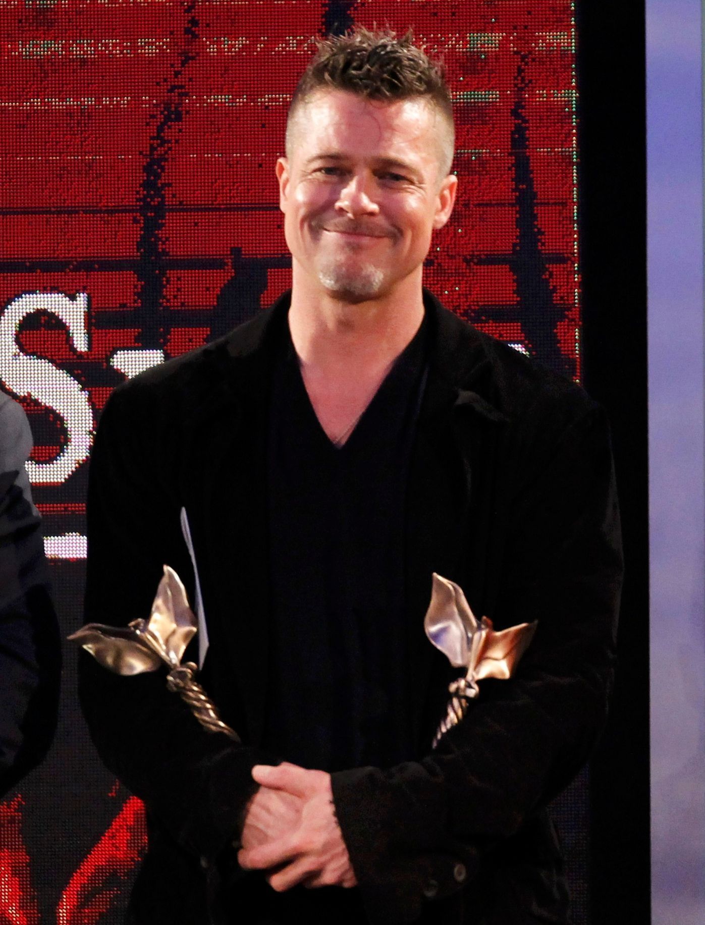 Actor Brad Pitt, a producer of the film &quot;12 Years a Slave,&quot; holds two Film Independent Spirit Awards after the film won the Best Feature Award at the 2014 Film Independent Spirit Awards in S