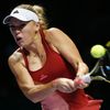 Caroline Wozniacki of Denmark hits a return to Serena Williams of the U.S. during their WTA Finals singles semi-finals tennis match at the Singapore Indoor Stadium