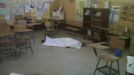 The body of a student lies in a classroom at a primary school in Tactic, in Alta Verapaz region, some 189km (117 miles) from Guatemala City, September 12, 2012. According to local media, a man entered the school and killed two children, one 8-years-old and the other 13, with a machete. The man was later lynched by a mob, who beat him up and burned him alive. REUTERS/Volunteers Firefighters/Handout (GUATEMALA - Tags: EDUCATION CRIME LAW) FOR EDITORIAL USE ONLY. NOT FOR SALE FOR MARKETING OR ADVERTISING CAMPAIGNS. THIS IMAGE HAS BEEN SUPPLIED BY A THIRD PARTY. IT IS DISTRIBUTED, EXACTLY AS RECEIVED BY REUTERS, AS A SERVICE TO CLIENTS Published: Zář. 12, 2012, 8:33 odp.