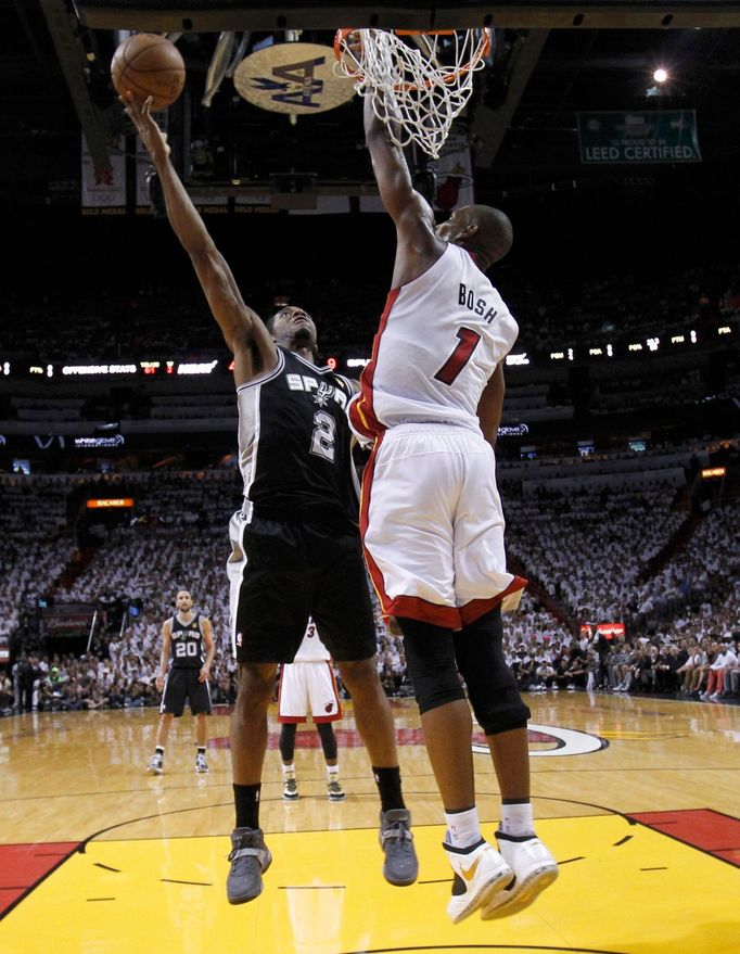 San Antonio Spurs small forward Kawhi Leonard (2) scores on Miami Heat center Chris Bosh (1) in the first half during Game 7 of their NBA Finals basketball playoff in Mia