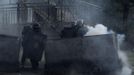 A home-made rocket explodes next to Spanish national riot police as they take cover behind mine wagons during clashes with coal miners in the surroundings of the "El Soton" coal mine in El Entrego, near Oviedo, northern Spain June 15, 2012. The miners were protesting against the government's proposal to decrease funding for coal production. REUTERS/Eloy Alonso (SPAIN - Tags: CIVIL UNREST BUSINESS EMPLOYMENT ENERGY) Published: Čer. 15, 2012, 12:14 odp.