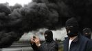 Miners on strike take pictures near barricades of burning tyres on the A-6 motorway, on the second day of a strike to protest the government's spending cuts in the mining sector, in El Montico, near Oviedo, northern Spain, May 24, 2012. Spain's economy is contracting for the second time since late 2009 and four years of stagnation and recession have pushed unemployment above 24 percent, the highest rate in the European Union. REUTERS/Eloy Alonso (CIVIL UNREST BUSINESS EMPLOYMENT ENERGY TPX IMAGES OF THE DAY) Published: Kvě. 24, 2012, 10:03 dop.