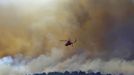 A fire fighting helicopter flies over the Wood Hollow fire, north of Fairview, Utah, June 26, 2012. More than 500 structures have been threatened by the Wood Hollow fire, forcing up to 1,500 people from homes. REUTERS/George Frey (UNITED STATES - Tags: ENVIRONMENT DISASTER) Published: Čer. 26, 2012, 9:34 odp.