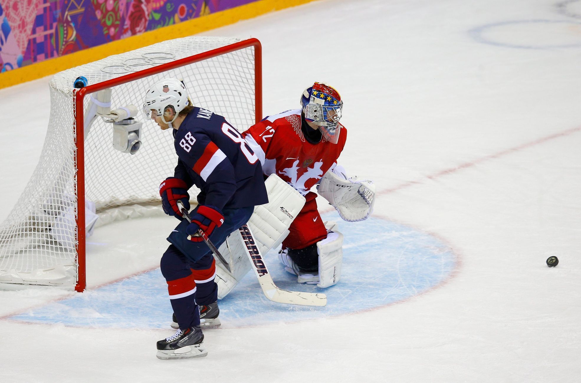 Russia's goalie Bobrovski makes a save on a breakaway by Team USA's Kane during overtime in their men's preliminary round ice hockey game at the 2014 Sochi Winter Olympic Games