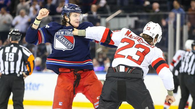 Apr 3, 2024; New York, New York, USA; New York Rangers center Matt Rempe (73) and New Jersey Devils defenseman Kurtis MacDermid (23) fight at start of the 1st period at M