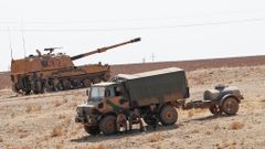 Turkish army vehicles and military personnel are stationed near the Turkish-Syrian border in Sanliurfa province